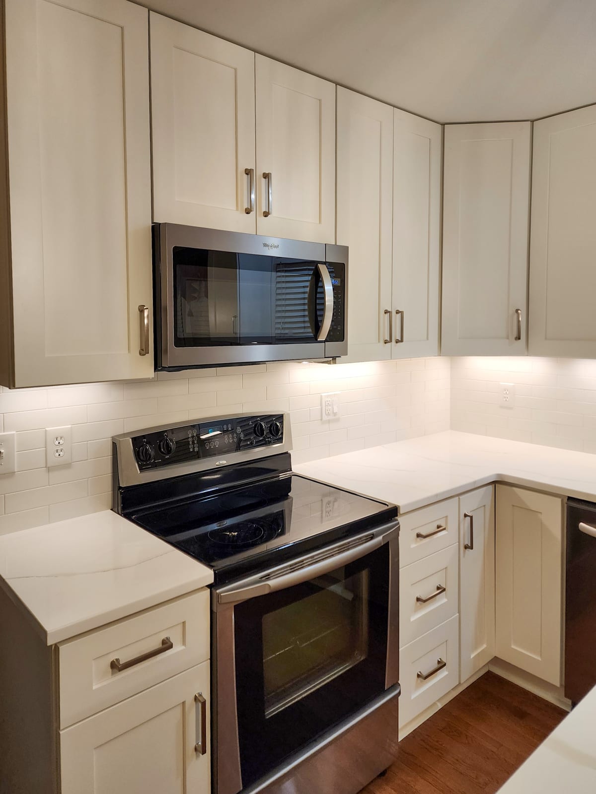 Kitchen remodel upper cabinets with microwave, range, and new countertop